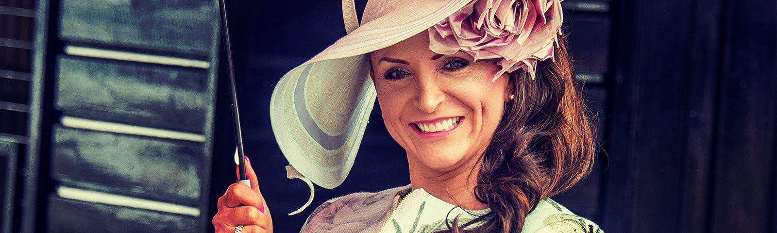 Dressed up lady attending racing at Brighton Racecourse.