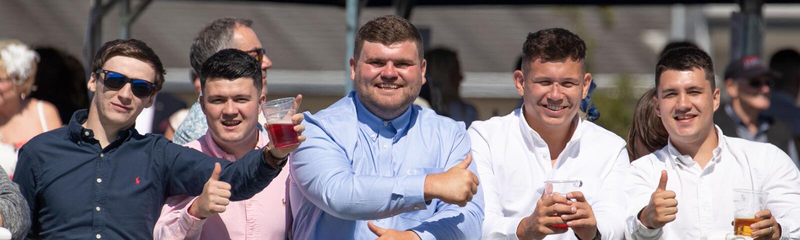 A group of guys enjoying a day at the races.