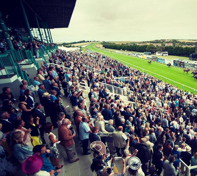 A packed grandstand wathcing a race