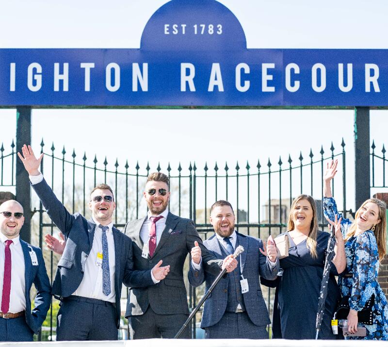 A group excited to enter Brighton Races