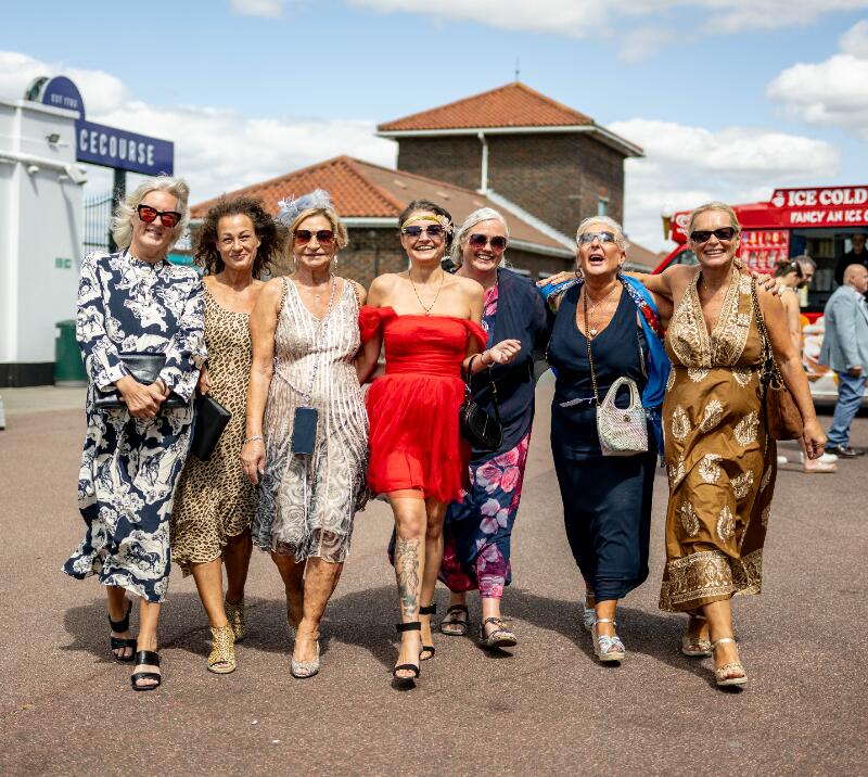 A group of ladies strutting their stuff coming in to Brighton Races
