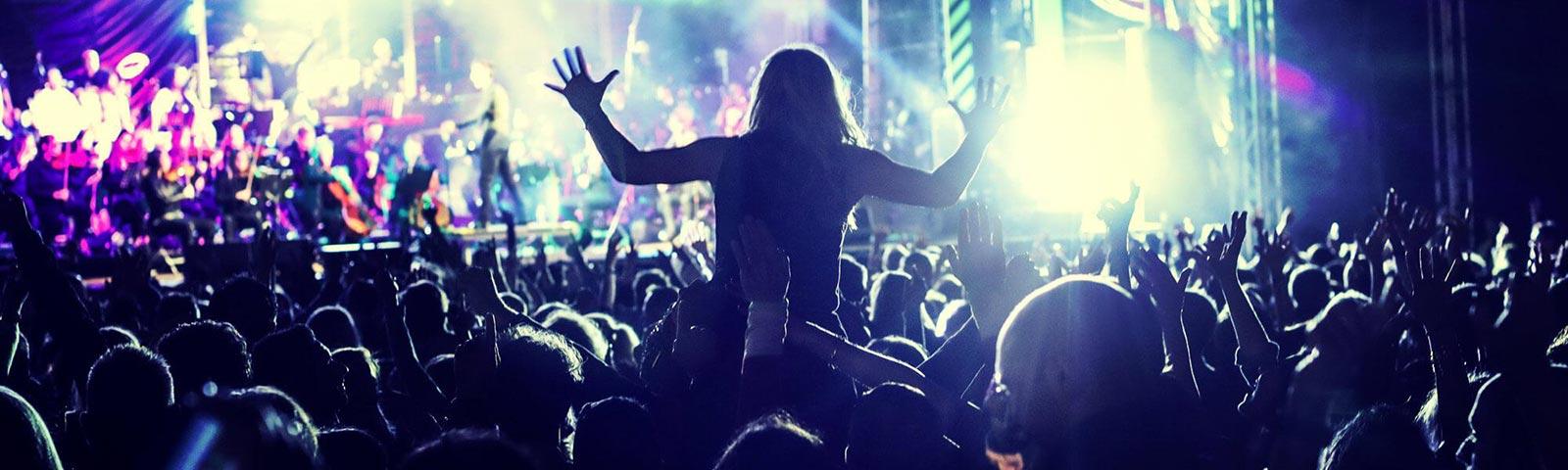 Crowds watching a live music act at Brighton Racecourse.