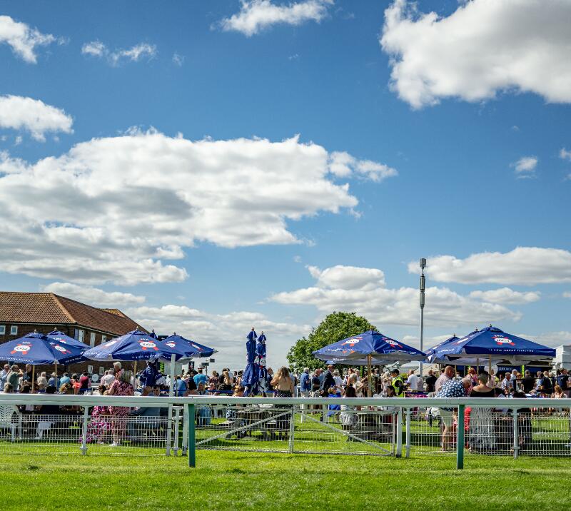 A sunny sky above tables and chairs at Brighton Racecourse